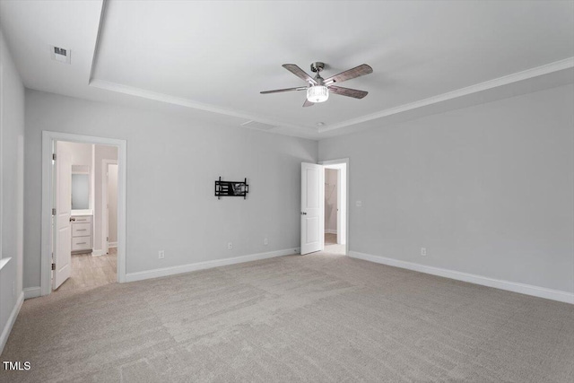 4940 Enlightenment Rd, Raleigh, NC 27616 - unfurnished bedroom with light colored carpet, a tray ceiling, ensuite bathroom, ceiling fan, and crown molding
