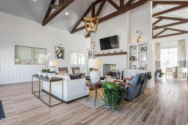 4940 Enlightenment Rd, Raleigh, NC 27616 - living room with high vaulted ceiling, beamed ceiling, and wood finished floors
