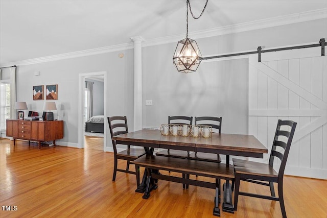 1819 Umstead Rd, Durham, NC 27712 - dining area with crown molding, light wood finished floors, a barn door, and a chandelier