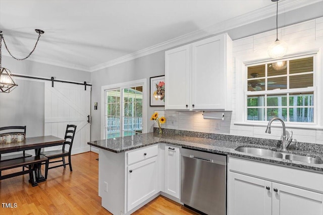 1819 Umstead Rd, Durham, NC 27712 - kitchen featuring dishwasher, a peninsula, a barn door, white cabinetry, and light wood-style flooring