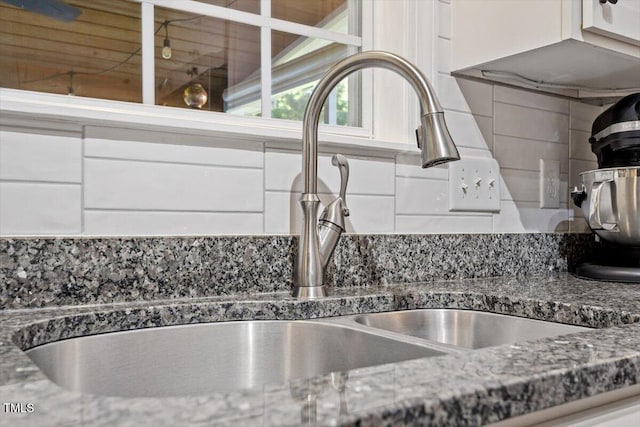 1819 Umstead Rd, Durham, NC 27712 - kitchen view of white cabinets, decorative backsplash, and dark stone counters