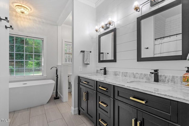 1819 Umstead Rd, Durham, NC 27712 - bathroom featuring ornamental molding, double vanity, a freestanding bath, and tile patterned flooring