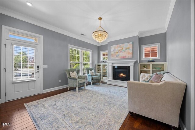 1330 Rodessa, Raleigh, NC 27607 - living room featuring dark wood-style flooring, crown molding, a chandelier, and a glass covered fireplace