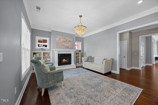 1330 Rodessa, Raleigh, NC 27607 - living area featuring ornamental molding, wood finished floors, a chandelier, and a glass covered fireplace