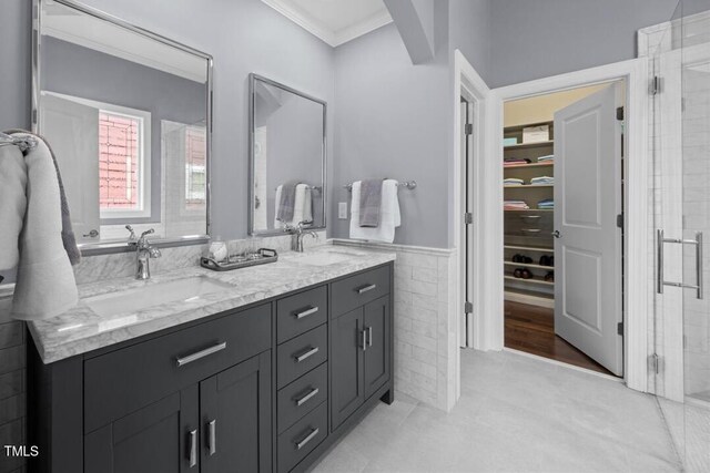 1330 Rodessa, Raleigh, NC 27607 - bathroom with double vanity, a shower stall, crown molding, tile walls, and wainscoting