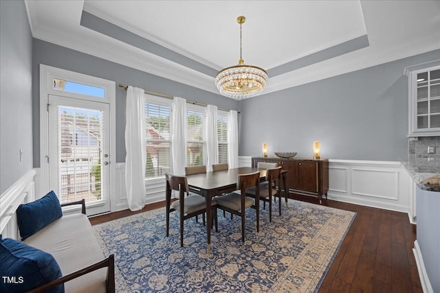 1330 Rodessa, Raleigh, NC 27607 - dining area featuring a chandelier, ornamental molding, a tray ceiling, wainscoting, and dark wood-style flooring