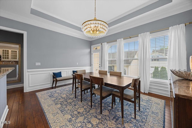 1330 Rodessa, Raleigh, NC 27607 - dining space with a chandelier, ornamental molding, dark wood-type flooring, a raised ceiling, and wainscoting