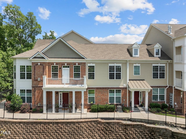 10310 Sablewood Dr Unit 211, Raleigh, NC 27617 - view of front of house with a patio area, brick siding, a balcony, and roof with shingles