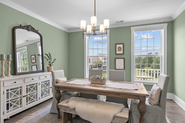 10310 Sablewood Dr Unit 211, Raleigh, NC 27617 - dining area with a chandelier, wood finished floors, and ornamental molding