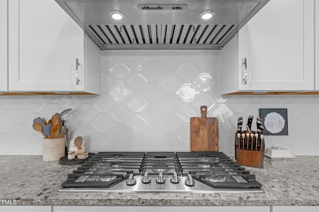 10310 Sablewood Dr Unit 211, Raleigh, NC 27617 - kitchen featuring ventilation hood, stainless steel gas stovetop, backsplash, and white cabinets
