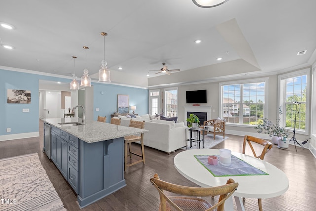10310 Sablewood Dr Unit 211, Raleigh, NC 27617 - kitchen with ceiling fan, an island with sink, a fireplace, dark wood-style floors, and dishwasher