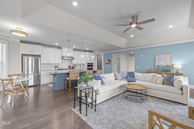 10310 Sablewood Dr Unit 211, Raleigh, NC 27617 - living room featuring dark wood-style flooring, recessed lighting, ceiling fan, and a tray ceiling