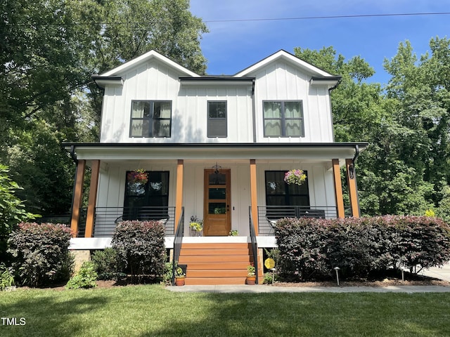 517 Bart St, Raleigh, NC 27610 - modern farmhouse featuring board and batten siding, a porch, and a front lawn