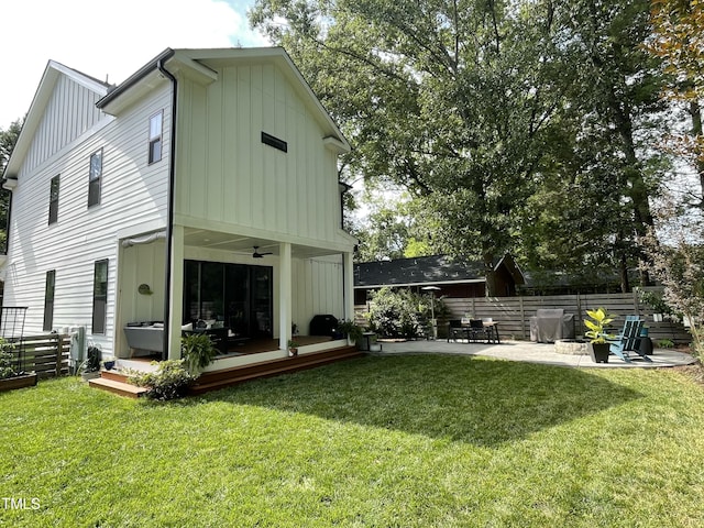 517 Bart St, Raleigh, NC 27610 - back of property with board and batten siding, a deck, and a patio