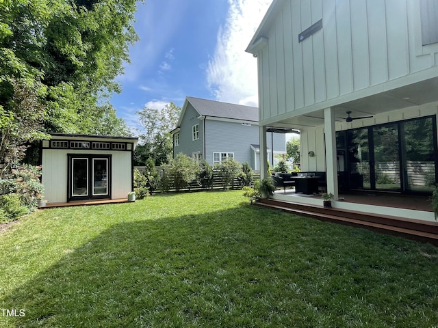 517 Bart St, Raleigh, NC 27610 - view of yard featuring a deck, ceiling fan, and an outdoor structure