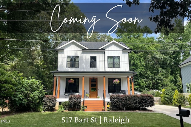 517 Bart St, Raleigh, NC 27610 - view of front of house featuring a porch, board and batten siding, and a front lawn