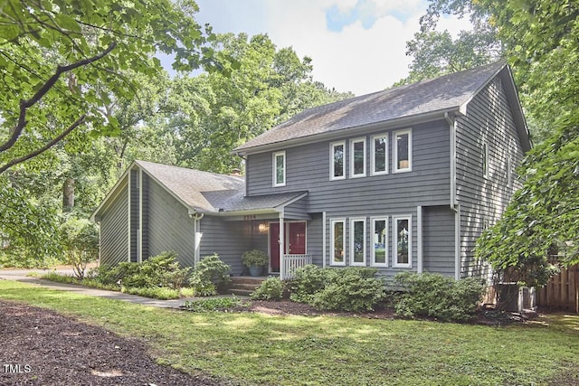 2334 Dawn Trl, Durham, NC 27712 - view of front of home featuring a front lawn, covered porch, and a shingled roof