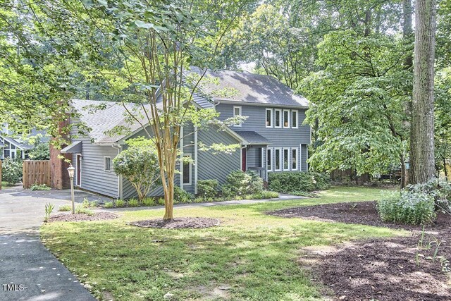 2334 Dawn Trl, Durham, NC 27712 - view of front facade featuring driveway and roof with shingles