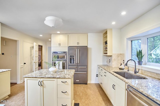 2334 Dawn Trl, Durham, NC 27712 - kitchen with appliances with stainless steel finishes, open shelves, light carpet, a center island, and recessed lighting