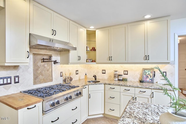 2334 Dawn Trl, Durham, NC 27712 - kitchen with under cabinet range hood, stainless steel gas cooktop, light stone counters, decorative backsplash, and recessed lighting