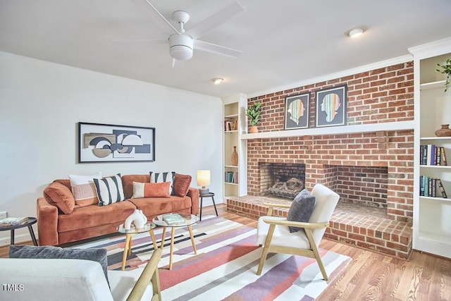 2334 Dawn Trl, Durham, NC 27712 - living area featuring a fireplace, wood finished floors, a ceiling fan, and built in features