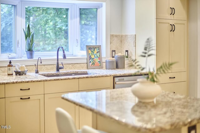 2334 Dawn Trl, Durham, NC 27712 - kitchen featuring stainless steel dishwasher, light stone countertops, and white cabinetry