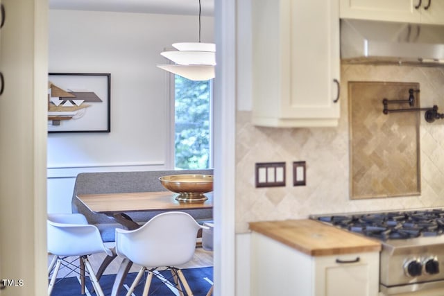 2334 Dawn Trl, Durham, NC 27712 - kitchen featuring stove, ventilation hood, decorative backsplash, wooden counters, and white cabinets