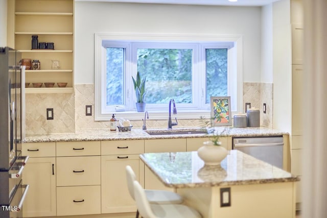 2334 Dawn Trl, Durham, NC 27712 - kitchen featuring appliances with stainless steel finishes, light stone counters, and decorative backsplash