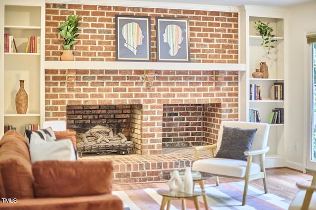 2334 Dawn Trl, Durham, NC 27712 - living room with a fireplace, wood finished floors, crown molding, and built in shelves