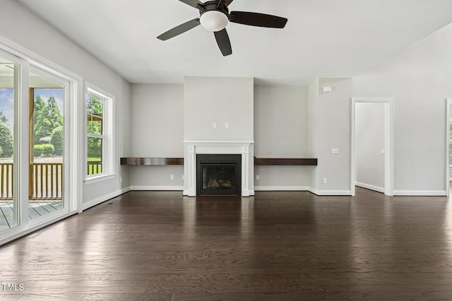 1625 Banks View Dr, Raleigh, NC 27603 - unfurnished living room with dark wood-type flooring, a ceiling fan, and a glass covered fireplace