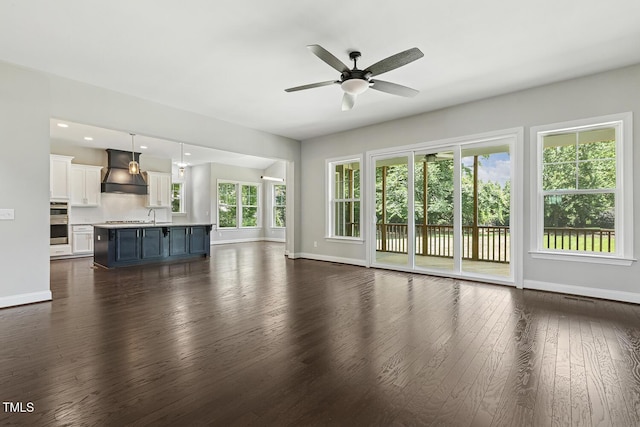 1625 Banks View Dr, Raleigh, NC 27603 - unfurnished living room featuring dark wood finished floors, a ceiling fan, and recessed lighting