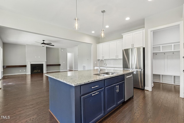 1625 Banks View Dr, Raleigh, NC 27603 - kitchen featuring appliances with stainless steel finishes, ceiling fan, blue cabinets, dark wood-type flooring, and white cabinetry