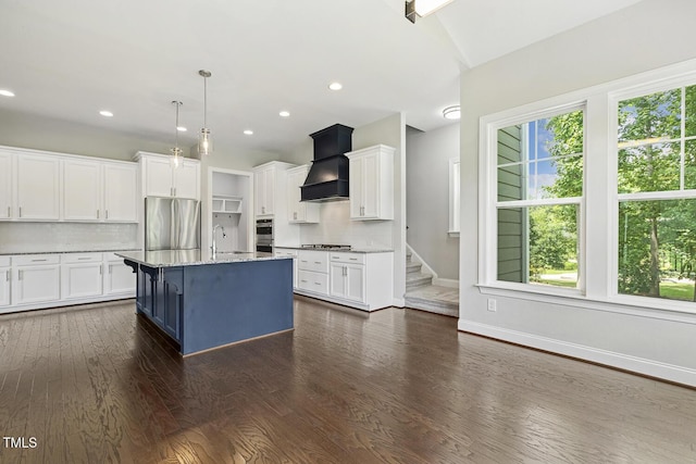 1625 Banks View Dr, Raleigh, NC 27603 - kitchen featuring stainless steel appliances, premium range hood, tasteful backsplash, white cabinetry, and recessed lighting