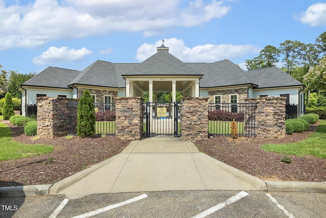 1625 Banks View Dr, Raleigh, NC 27603 - view of front facade with a gate, stone siding, uncovered parking, and a fenced front yard