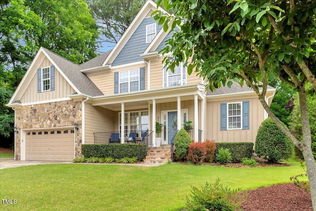 218 Kinvara Ct, Wake Forest, NC 27587 - view of front facade featuring covered porch, board and batten siding, a front yard, and driveway