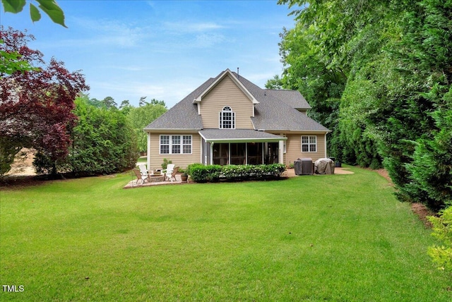 218 Kinvara Ct, Wake Forest, NC 27587 - back of property featuring a sunroom, a lawn, a patio area, and roof with shingles
