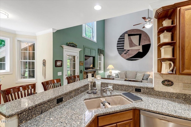 218 Kinvara Ct, Wake Forest, NC 27587 - kitchen featuring dishwasher, a ceiling fan, brown cabinets, stone counters, and crown molding