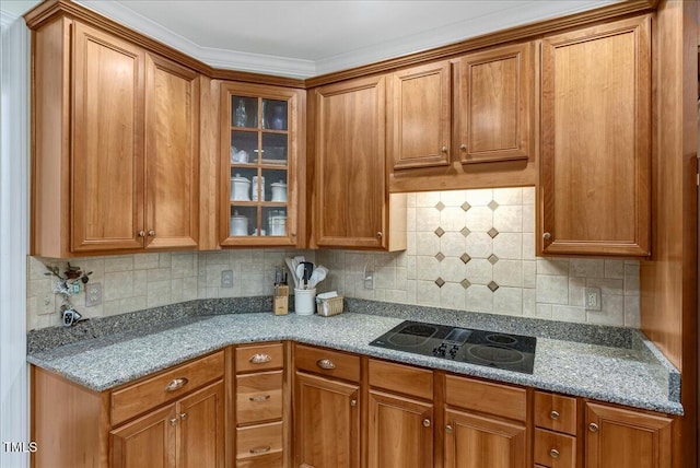 218 Kinvara Ct, Wake Forest, NC 27587 - kitchen featuring black electric stovetop, glass insert cabinets, brown cabinets, and backsplash
