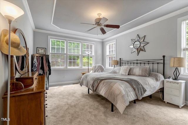 218 Kinvara Ct, Wake Forest, NC 27587 - bedroom with light colored carpet, a raised ceiling, ornamental molding, and a ceiling fan