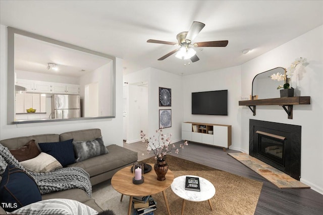 600 Audubon Lake Dr Unit 4B11, Durham, NC 27713 - living area with wood finished floors, ceiling fan, and a glass covered fireplace