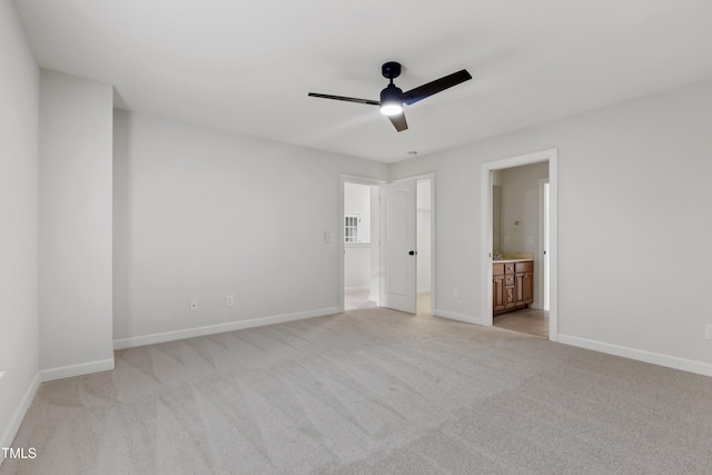 109 Aspenridge Dr, Holly Springs, NC 27540 - unfurnished bedroom featuring light colored carpet, ensuite bathroom, a ceiling fan, and a spacious closet