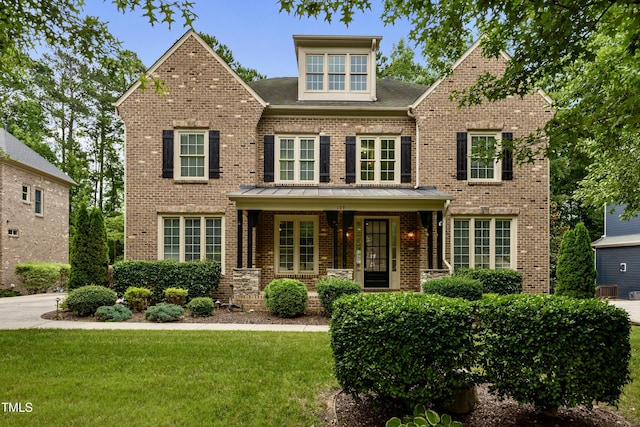109 Aspenridge Dr, Holly Springs, NC 27540 - view of front of home featuring brick siding, a front lawn, and covered porch