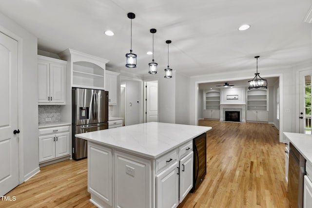 109 Aspenridge Dr, Holly Springs, NC 27540 - kitchen with stainless steel refrigerator with ice dispenser, wine cooler, open shelves, light wood finished floors, and white cabinets