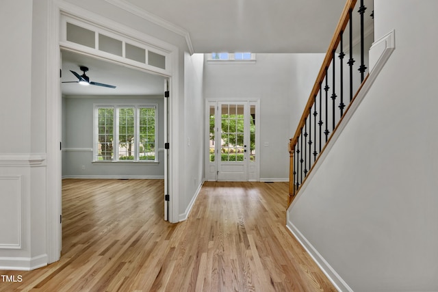109 Aspenridge Dr, Holly Springs, NC 27540 - foyer with light wood-type flooring, stairway, crown molding, and a ceiling fan