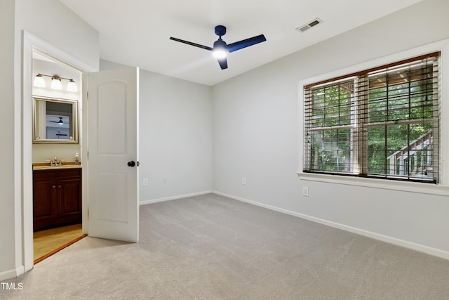 109 Aspenridge Dr, Holly Springs, NC 27540 - unfurnished bedroom with light colored carpet, ensuite bathroom, and a ceiling fan