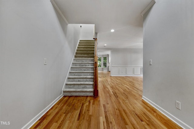 109 Aspenridge Dr, Holly Springs, NC 27540 - staircase featuring wood finished floors, recessed lighting, wainscoting, and a decorative wall