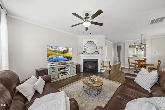 4413 Sugarbend Way, Raleigh, NC 27606 - living area featuring ceiling fan, dark wood-type flooring, ornamental molding, a chandelier, and a fireplace with flush hearth