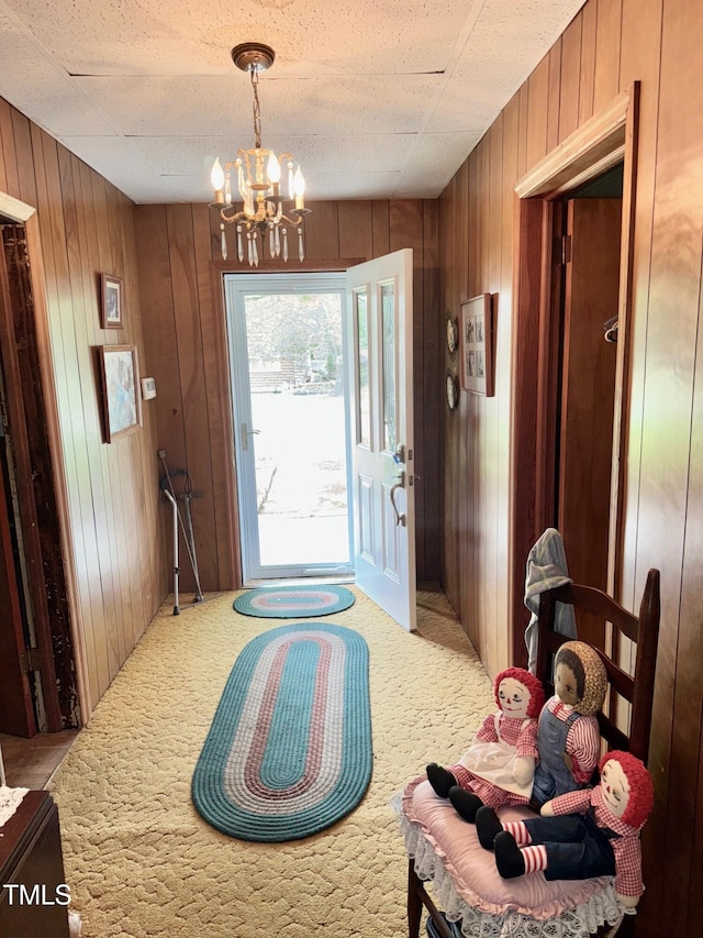 410 High St, Norlina, NC 27563 - foyer with wooden walls, a chandelier, and carpet floors