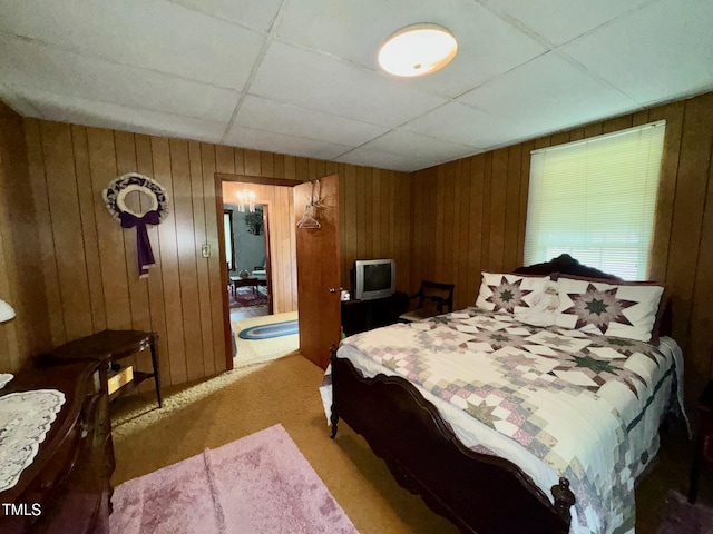410 High St, Norlina, NC 27563 - bedroom featuring light carpet, wood walls, and a paneled ceiling