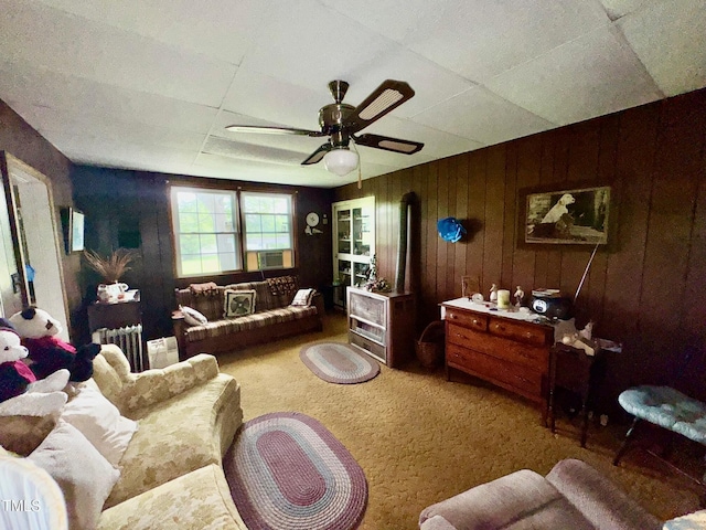 410 High St, Norlina, NC 27563 - carpeted living area with a ceiling fan, wooden walls, radiator heating unit, and cooling unit